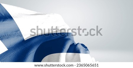 Finland national flag cloth fabric waving on beautiful light grey Background.