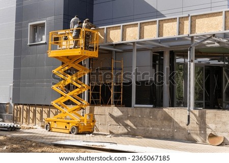 mobile lifting cradle. Construction scissor lift. Royalty-Free Stock Photo #2365067185