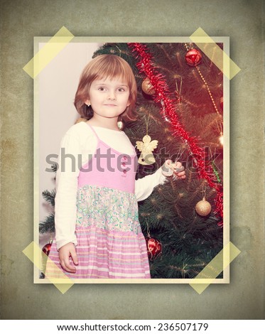 young thoughtful girl with Christmas tree - vintage picture on grunge background with stick papers