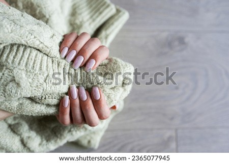 Women's hands with colorful pattern on the nails. Top view. Place for text. 