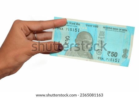 Lady Hand Hold Indian New Currency 50 Rupees Note. Indian Currency giving money to another person fifty  Rupees Note. Royalty-Free Stock Photo #2365081163