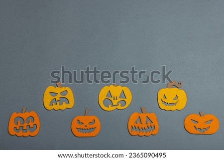 Funny Halloween background. Traditional colorful fall pumpkins with different faces. Festive flat lay, classic autumn style, top view