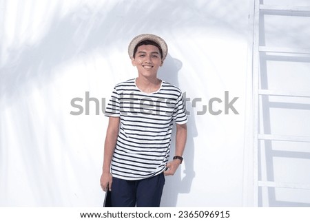 portrait of in a male standing with ladder isolated on white background