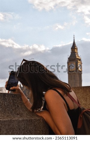 Girl taking picture of Big Ben