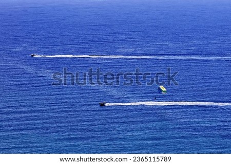 water rides test courage in the mediterranean sea two boats pull a parachute