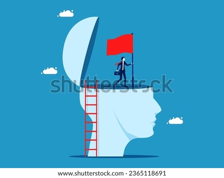 Inspiration to succeed. Businessman plants victory flag on big head
