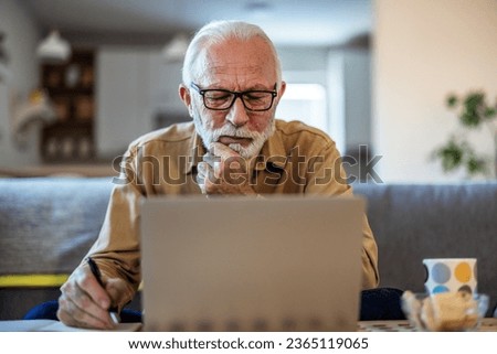 Finance, retirement and old man with paperwork, laptop and budget plan, checking investment and taxes. Mortgage, insurance document and online pension savings review, senior man with debt in home. Royalty-Free Stock Photo #2365119065