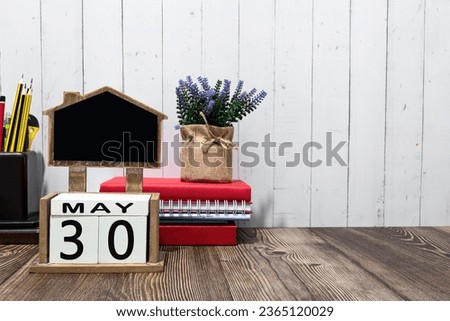 May 30th calendar date text on white wooden block on wooden desk
