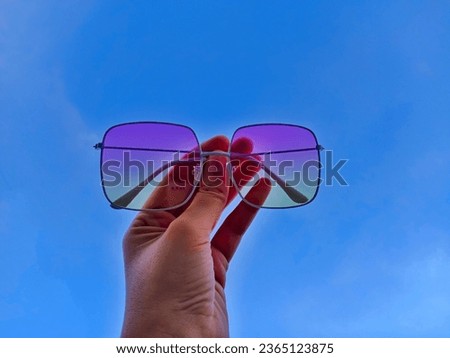 Blue sunglasses against the sky.