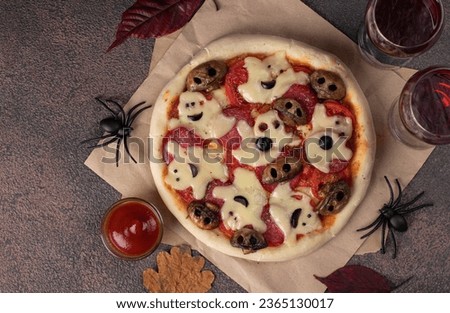 Themed food for Halloween - pizza with cheese ghosts and mushrooms form of skulls, Top view