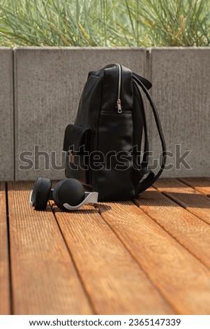black leather backpack, industrial photography outdor