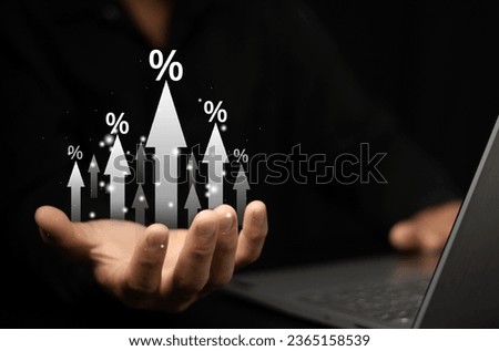 Businessman showing percentage icons and up arrow icons with graph indicators. Concept of financial interest rates and mortgage rates. Interest Rates Stocks Finance Ratings Mortgage Rates.
