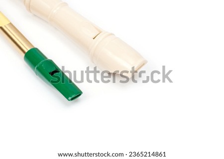 Irish whistle and block flute are longitudinal flutes with a whistle device and playing holes. Royalty-Free Stock Photo #2365214861