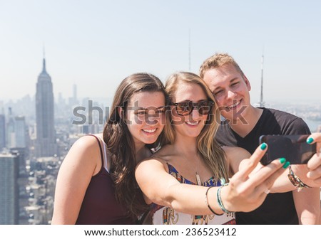 Friends Taking Selfie with New York on Background