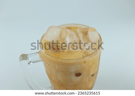 top view Thai orange Tea with ice in thick glass traditional drink famous in Thailand many people like it menu in cafe creamy milk latte side view isolated white background  