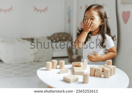 children boy and girl play with wooden toys at home in children's bedroom Royalty-Free Stock Photo #2365252611