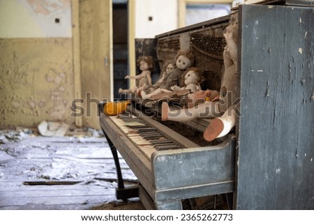 Interior decoration of abandoned private houses with piano and dolls in the exclusion zone of Belarus.