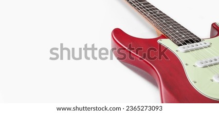 Part of an electric guitar on a white background. Free space. Selective focus on the fretboard. Royalty-Free Stock Photo #2365273093