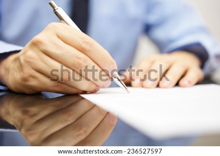 businessman is writing a letter or signing a agreement