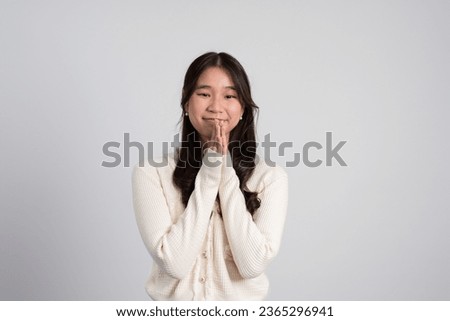 Happy cheerful young Asian girl with long light hair smiling brightly feeling happy with a positive expression, joyful surprise funky, Female in black with a big smile isolated on white background.