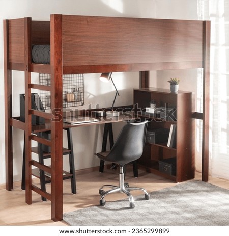 Modern Workspace Bedroom with a Mid-Century Full Loft Bed, Wooden Corner Desk with Storage and Computer, Accented by a Black Office Chair, Against White Walls Royalty-Free Stock Photo #2365299899