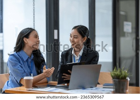 Two asian businesswoman discussing investment project work on data chart and planning strategy. About the new business in the online financial world Asian startup business ideas.