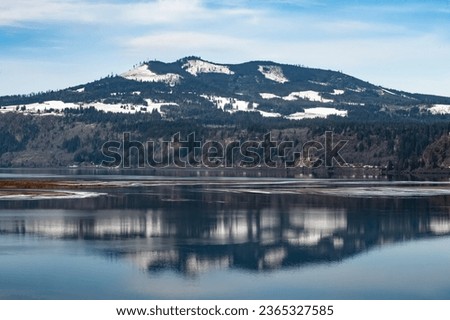 Mountain Reflection on Columbia River with train.
