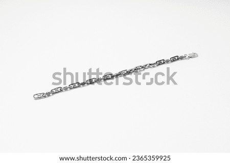 Silver chain on white background, subject macro photography
