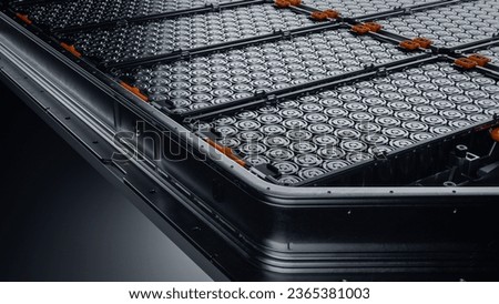 Close-up of EV Battery Pack with Orange Connectors Isolated on Black Background. High Capacity Battery for Automotive Industry Lithium-ion High-voltage Battery for Electric Vehicle or Hybrid Car. Royalty-Free Stock Photo #2365381003