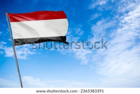 Yemen Flag - The distinctive flag of Yemen fluttering gracefully. This flag features horizontal bands of red, white, and black, with a vibrant red horizontal stripe along the bottom edge, symbolizing 