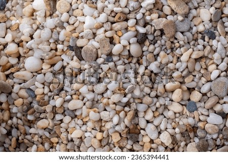 Small stone structure for background. High quality photos.
Abstract nature sea pebbles background. Vintage beige color. Multicolored pebbles of different shapes (grey, orange, white, yellow) with abst