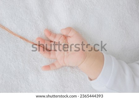hand of a child with a cross, baptism of a child. selective focus