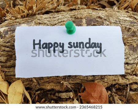 Happy sunday writing on wooden background.