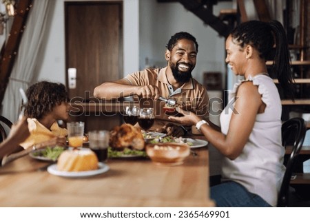 Happy African American family  having Thanksgiving dinner at dining table