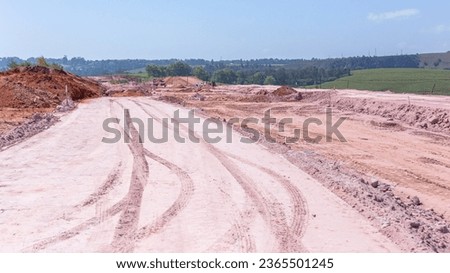 Construction New Roads Earthworks layout landscape moving sand compressing surfaces with heavy machines outdoors countryside economy expansion projects.