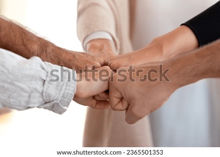 Close up of people fist bumping put hands together makes circle shape, loyalty, contribution symbol. Friendship support in business, common project aspiration intention take leading position concept Royalty-Free Stock Photo #2365501353