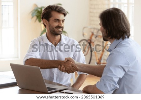 European confident manager and client shaking hands feels satisfied by fruitful negotiations. Employer hired new worker after successful job interview, hr headhunting, colleagues finish work concept Royalty-Free Stock Photo #2365501369