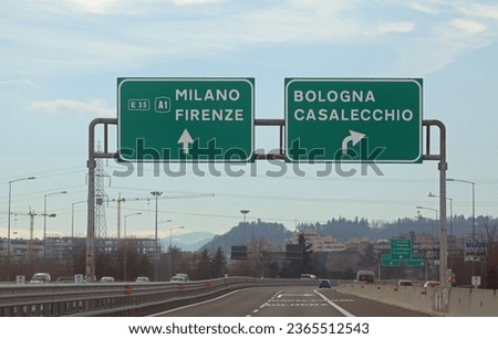 road sign with directions to reach Milan - Florence or Bologna and the crossroads in central Italy with very few cars