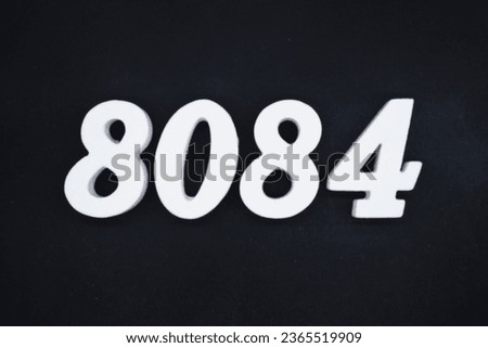 Black for the background. The number 8084 is made of white painted wood.