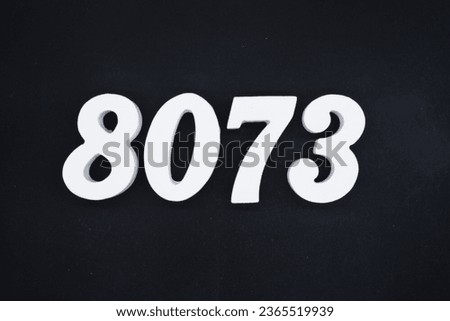 Black for the background. The number 8073 is made of white painted wood.