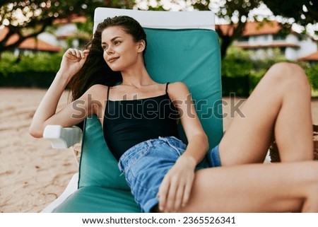 beach woman sunbed sea lying sand ocean resort lifestyle smiling attractive