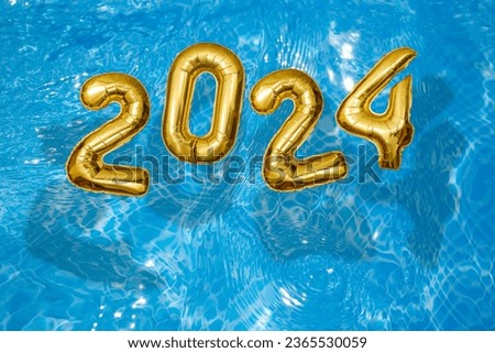 2024 Inflatable golden numbers on water ripples surface, happy new year with a swimming pool concept Royalty-Free Stock Photo #2365530059