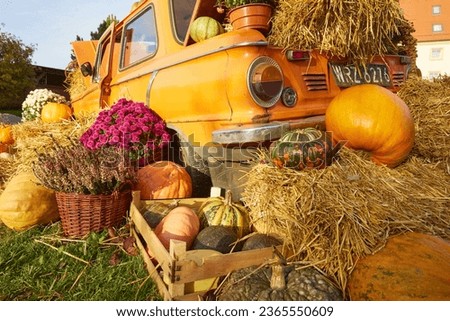 A fall harvest festival, the decorations created with hay pumpkins are just as indicative of the coming fall and approaching Halloween Royalty-Free Stock Photo #2365550609