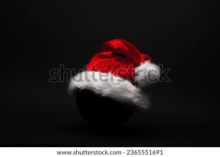 Red Christmas hat against dark background