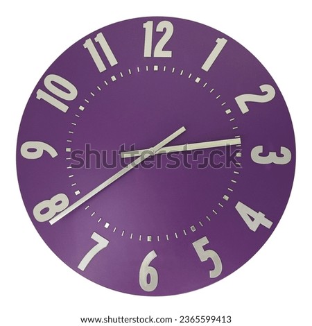A classic wall clock with silver numbers on purple isolated on a white background