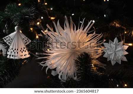 Origami decorations for the Christmas tree. Handmade, hobby Christmas tree toys. Paper crafts, handcrafts, homemade, handworks. Postcard, background for Christmas and new year. Angel and snowflake.