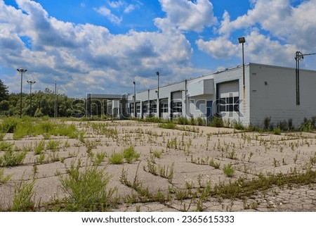 Showing an abandoned auto dealership background. Royalty-Free Stock Photo #2365615333