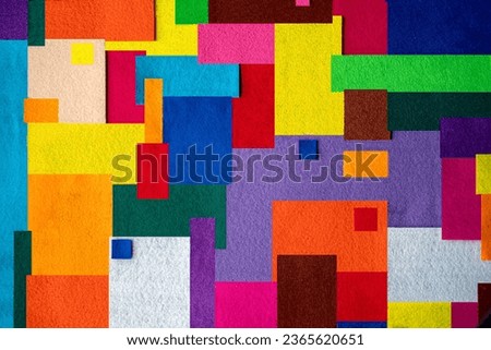 Colorful texture created with pieces of felt fabric of different colors in square and rectangular shapes Royalty-Free Stock Photo #2365620651