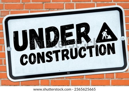 Under Construction Sign on Brick Wall