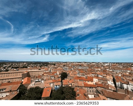 Panoramic top-view shot of Beziers showcases the striking terracotta roofs of the city, offering a vivid and detailed portrayal of this iconic architectural feature